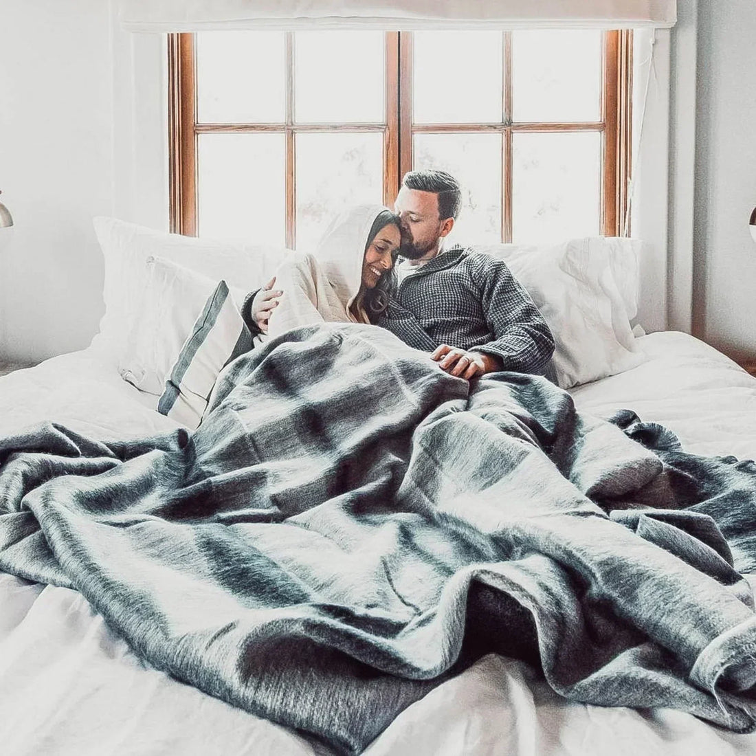 A couple sharing a Pokoloko blanket.