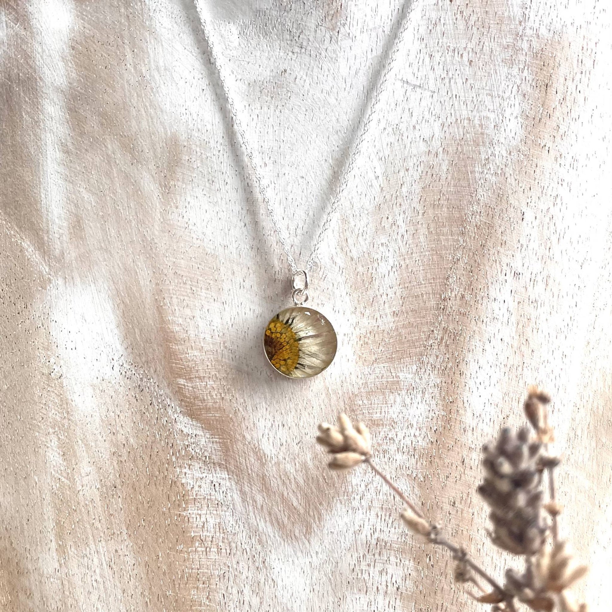 Necklace with real daisy embedded in pendant