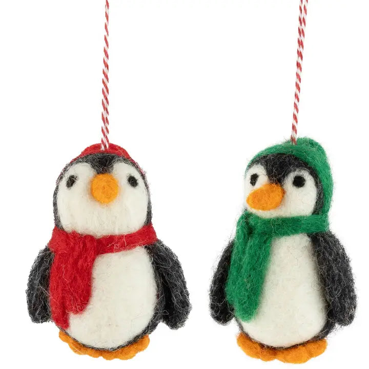 felted penguin ornament one with a red scarf and the other with a green scarf, on a white background.