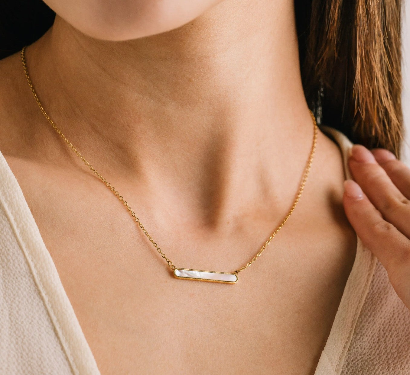 Gold necklace with a bar pendant