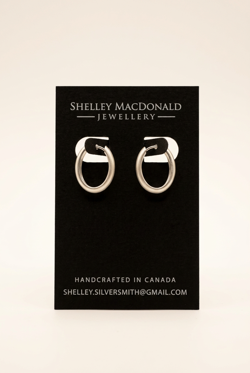Small Reversible Ovate Hoop Earrings with an upright display and cleaner background